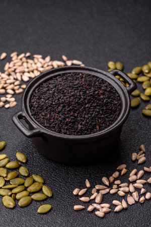 Black sesame seeds in a bowl, an ingredient for oil and healthy eating. Black sesame as a food background for your designの写真素材