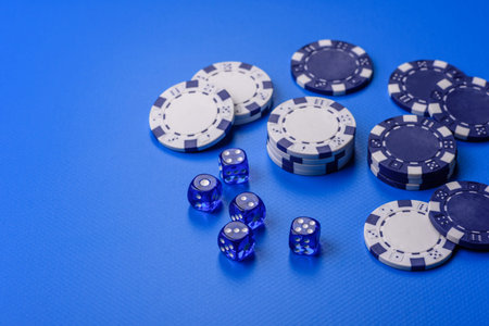 Casino dice and chips on a colored background, poker, gambling with bets. Dice and chips as a...