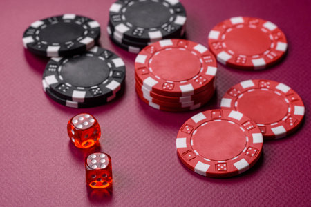 Casino dice and chips on a colored background, poker, gambling with bets. Dice and chips as a background for your designの写真素材