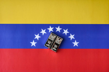 A silver bar, white metal against a flag of Venezuela, as a concept for the sales market. A silver bar as a background for your designの写真素材