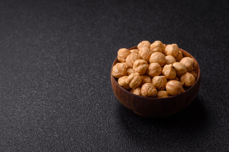 Whole peeled hazelnuts, roasted or raw, as an ingredient for healthy food. Hazelnuts as a background...