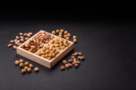A box of cashews, hazelnuts, pistachios, and Brazil nuts as healthy food ingredients. A box of nuts...