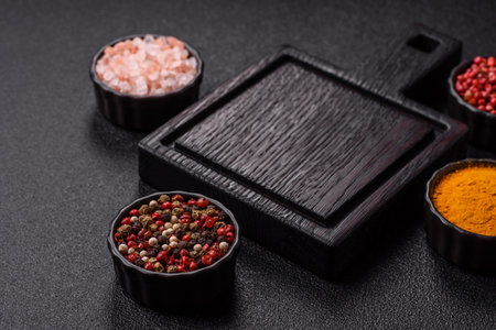 An empty wooden cutting board with cutlery on a kitchen counter. A wooden cutting board as a food background for your designの写真素材