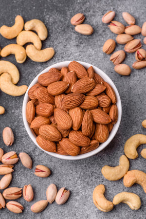 Raw and peeled almonds as a healthy food ingredient. Almonds as a food background for your designの写真素材