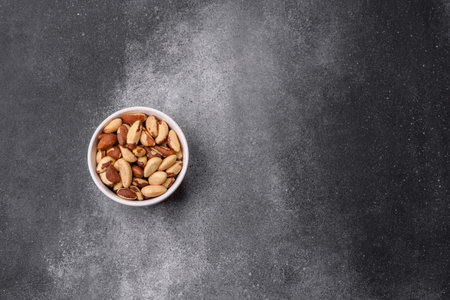 Brazil nuts, raw and shelled, are a source of selenium and a healthy food ingredient. Brazil nuts as a food background for your designの写真素材