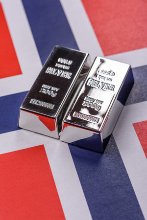 A silver bar, white metal against a backdrop of a flag, as a concept for the sales market. A silver bar as a background for your designの写真素材