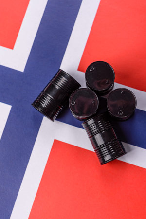 Metal barrels of oil, gas, or chemicals on the Norwegian flag, Norway production. Barrels of oil as a background for your designの写真素材