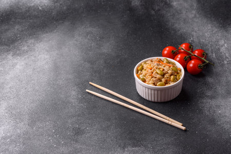 Rice with edamame and carrots as a food background for your designの写真素材