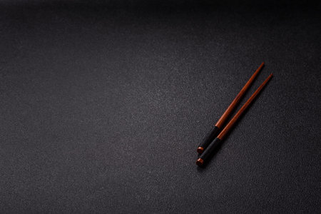 Wooden bamboo chopsticks for sushi and other Asian food with a blank background for text. Wooden...