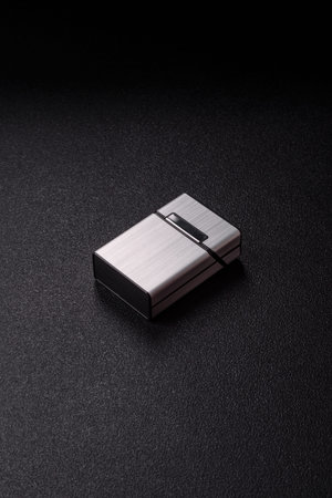 Metal cigarette box, harmful habits, nicotine use and the risk of cancer. Cigarette box as a...