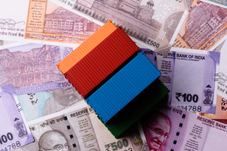 Cargo containers on the Indian money as a conceptual backdrop for goods export and logistics. Cargo...