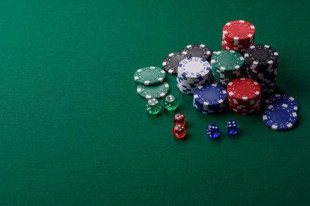 Multicolored casino chips as a conceptual backdrop for gambling games like poker, blackjack, or baccarat. Multicolored casino chips as a backdrop for your design