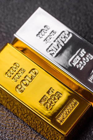 Gold and silver bullion or ingots as metals for bank storage, investments, and financial transactions. Gold and silver bars as a backdrop for your design.