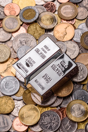 A silver bar, white metal against a backdrop of money, as a concept for the sales market. A silver bar as a background for your design