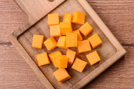 Hard yellow cheddar cheese for sandwiches or pasta. Cheddar cheese as a food background for your design