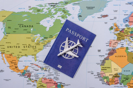 International passport against a map backdrop, representing the concepts of travel, hiking, and relocation. Passport on a map as a background for your design.