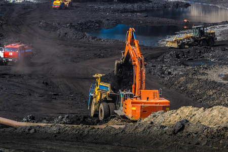 Loading mining trucks an excavator