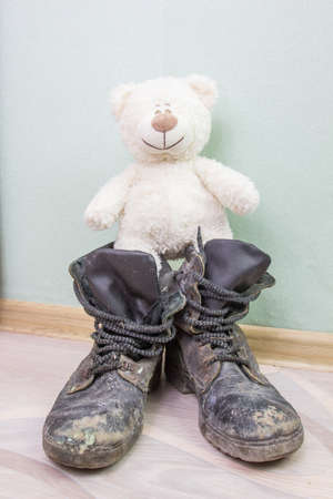 Children's toy and old army boots.の写真素材