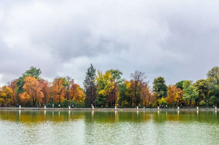 beautiful large lake and colorful autumn trees in the Buen Retiro Park near the Monument to Alfonso XII. Madrid, Spainの写真素材