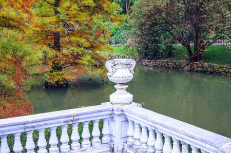 White railing with a vase in antique style with Baluster and pond near the Palacio de Cristal in the Buen Retiro park. Madrid, Spainの写真素材