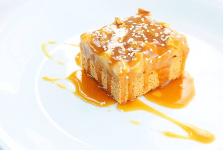 Apple caramel cake on a white background.の写真素材