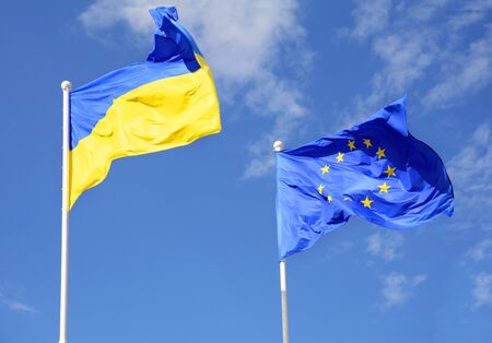 Flags of Ukraine and European Union (EU) fluttering in the windの写真素材