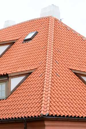 Red ceramic Shingles Roof with attic Windows. Ceramic tiles roof.の写真素材
