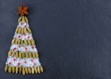 Various Spices Background. Spices on Christmas background. Christmas tree of spices on a dark  backgroundの写真素材