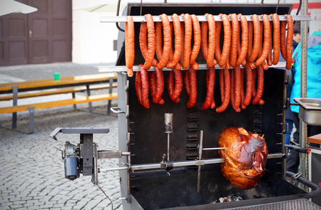 Delicious grilled meat with sausages over the coals on a barbecue.の写真素材