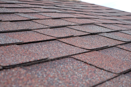 Close up view on asphalt roofing shingles.の写真素材