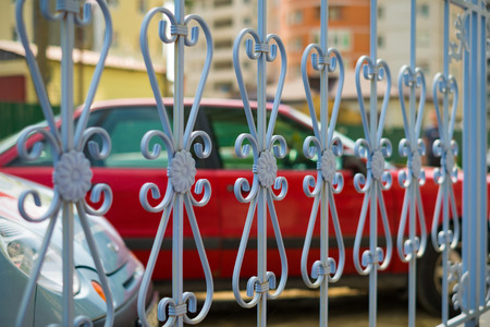 Image of a new decorative wrought fence with artistic forging. Metal guardrail close up.