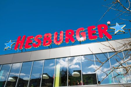 Irpin, Ukraine - March 9, 2019: Logo of Finnish fast food company Hesburger on the roof.のeditorial素材