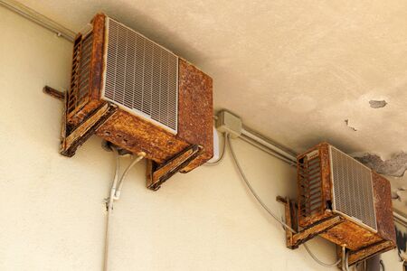 Old rusty air conditioner requiring repair or replacement outdoor unit. An example of the influence of air and climate control.の写真素材