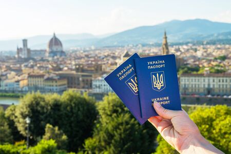 Ukrainian blue biometric passport with identification chip on against Florence background.の写真素材
