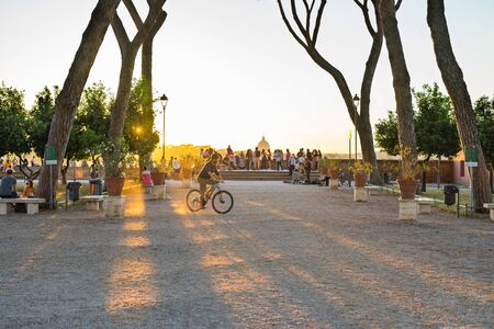 Rome, Italy - June 24, 2019: People enjoy sunset from the orange trees garden on the Aventine Hill...
