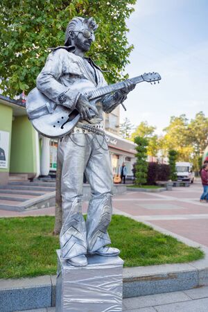 Irpin, Ukraine - September 21, 2019: Living statue rocker man with guitar is the entertainment for passerby.のeditorial素材