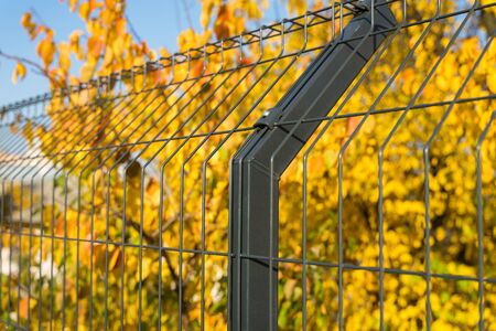 Steel grating fence made with wire on blue sky background. Sectional fencing installation