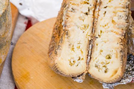 Closeup aged soft cheese on a served on wooden background. Dairy delicacies.の写真素材