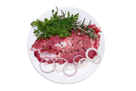 Raw steak with fresh onions and spicesの写真素材