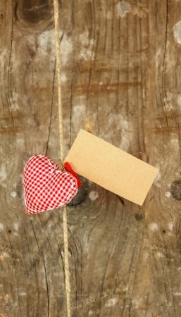 fabric heart with empty paper on stringの写真素材