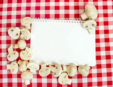  background for cooking recipes, mushrooms around blank paperの写真素材