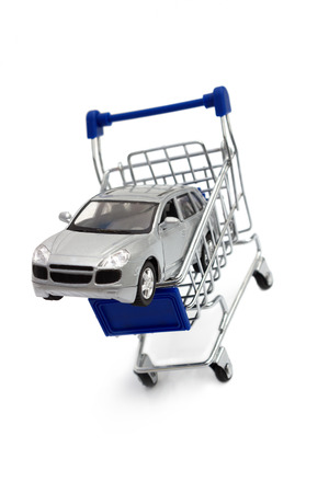 A car in a shopping cart isolated on whiteの写真素材
