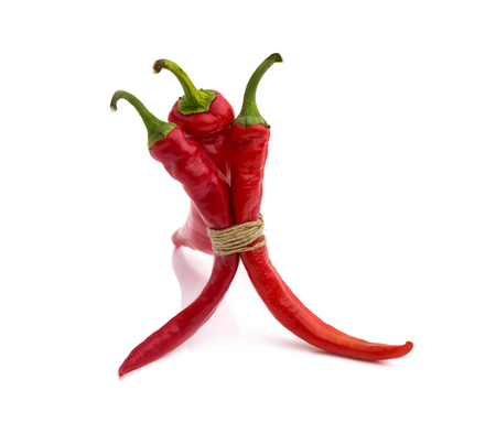 Three red hot chili pepper isolated on a white backgroundの写真素材