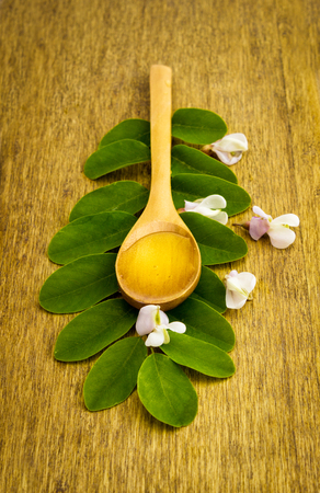 Honey of acacia in wooden spoonの写真素材
