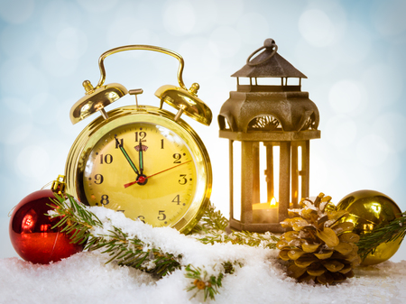 Happy New Year message with gold retro clock showing five to midnight on starry background with  Christmas lights.の写真素材