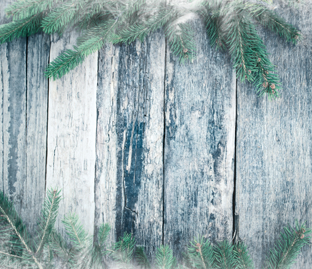 Christmas fir on wooden table, holiday backgroundの写真素材