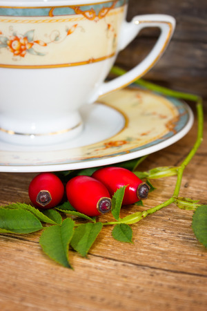 Fresh rose hip and drink a cup of rose hipsの写真素材