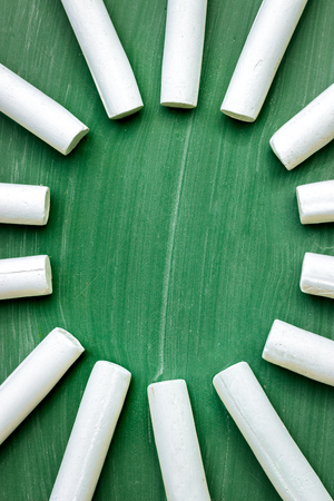 circle of chalk formed on a green chalkboard,  center  of blackboard is empty with copy spaceの写真素材