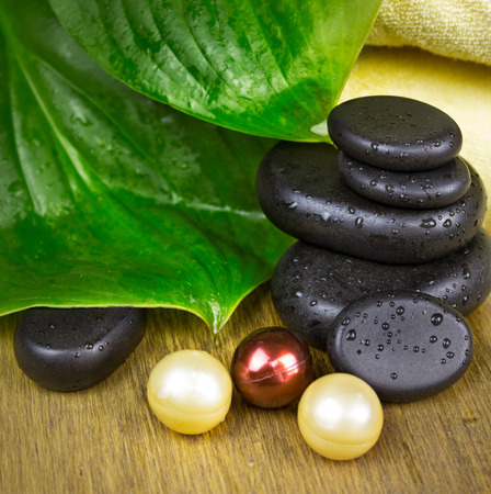 massage stones with soap on wooden backgroundの写真素材