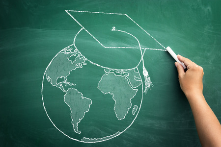 world globe with graduation cap, concept diplomas confessed throughout the worldの写真素材